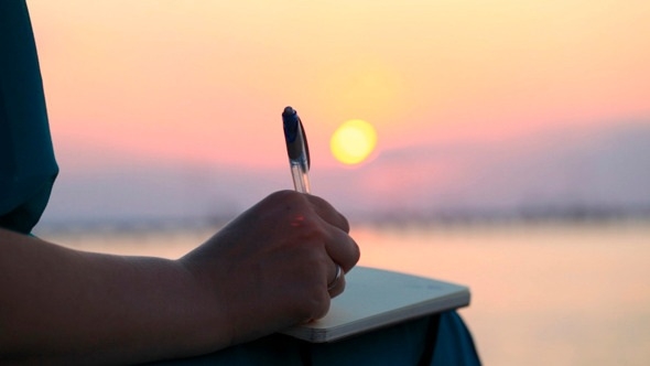 Woman Writing In Her Diary At Sunset By Grey_Coast_Media | Videohive intended for Woman Writing In Diary